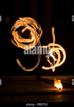 Performers are spinning torches while performing a fire show at night celebrating the international Earth hour event in Sofia, B Stock Photo