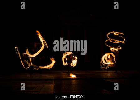 Performers are spinning torches while performing a fire show at night celebrating the international Earth hour event in Sofia, B Stock Photo