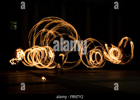 Performers are spinning torches while performing a fire show at night celebrating the international Earth hour event in Sofia, B Stock Photo