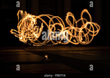 Performers are spinning torches while performing a fire show at night celebrating the international Earth hour event in Sofia, B Stock Photo