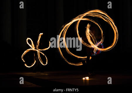 Performers are spinning torches while performing a fire show at night celebrating the international Earth hour event in Sofia, B Stock Photo