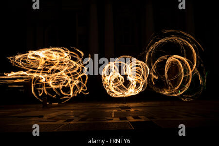 Performers are spinning torches while performing a fire show at night celebrating the international Earth hour event in Sofia, B Stock Photo