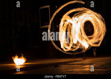 Performers are spinning torches while performing a fire show at night celebrating the international Earth hour event in Sofia, B Stock Photo