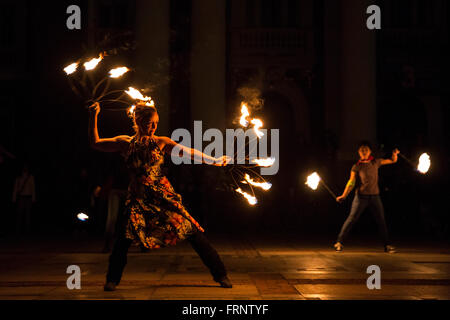 Sofia, Bulgaria - March 19, 2016: Performers are spinning torches while performing a fire show at night celebrating the internat Stock Photo