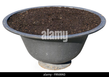 The pig-iron street flower vase is filled with compost. Isolated with patch Stock Photo