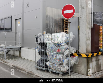 VILNIUS, LITHUANIA - MARCH 12, 2016: Plastic bags with the used bottles from under Coca Cola and other drinks are prepared for p Stock Photo