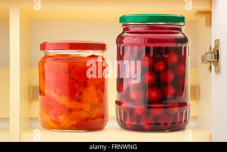 Pickled vegetables in jars on shelf in closeup Stock Photo