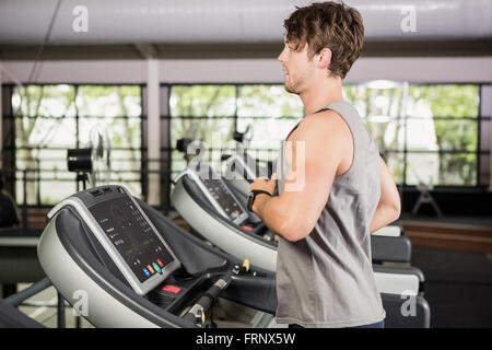 Man running on thread mill Stock Photo