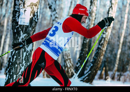closeup male skier middle-aged of classic style in winter woods on sports race during Championship of Chelyabinsk in cross Stock Photo