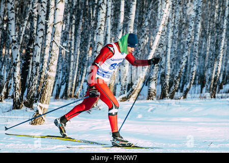closeup skier athlete winter birch forest sprint race in classic style during Championship of Chelyabinsk in cross-country skii Stock Photo