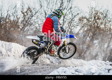 racer on a motorcycle jump on hill during Cup Winter motocross Stock Photo