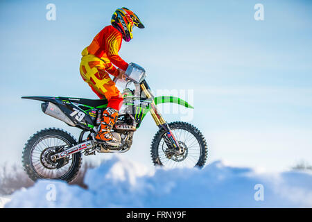 closeup rider on a motorcycle jump on mountain during Cup Winter motocross Stock Photo