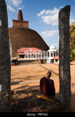 Sri Lanka, Anuradhapura, Abhayagiri Dagoba, Buddhist Monk sat in shade Stock Photo