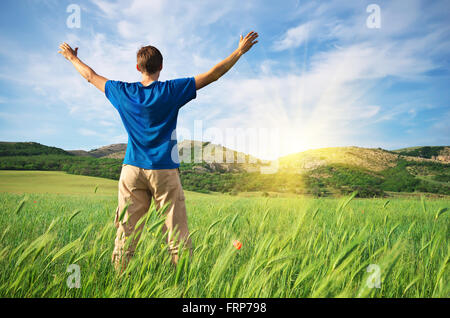 Man in green wheat meadow. Conceptual design. Stock Photo