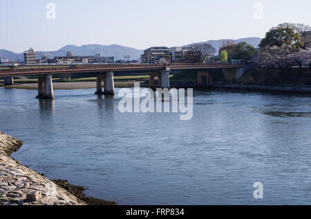 Tsurumi Bridge crossing the Asahigawa River in Okayama, to the right is the entrance to Koraken Garden, Chugoku Region, Japan Stock Photo