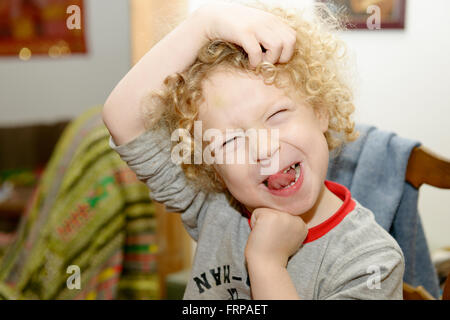a little blond boy making faces Stock Photo