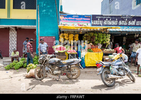 Fruit stall at the roadside in Maduranthakam, Kancheepuram district of Tamil Nadu, with local people and parked motorcycles Stock Photo