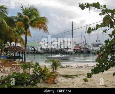 Cruise ships pack the port in the distance on Christmas Eve from this view on the beach at Simpson Bay. Stock Photo