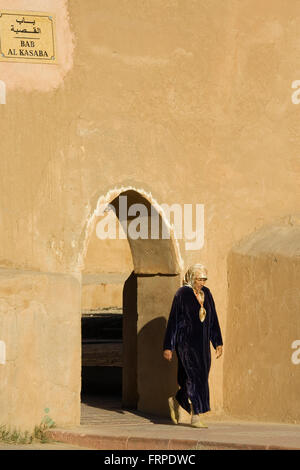 Woman walking through the Bab Al Kasaba gate at the town wall of Taroudant, Morocco Stock Photo