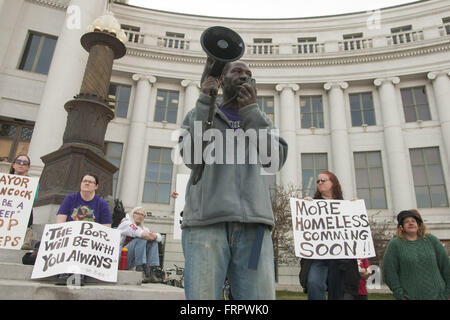 Denver, Colorado, USA. 21st Mar, 2016. In response to the crisis of homelessness in Denver, JERRY BURTON proposed the construction of tiny houses, the creation of spaces for the homeless to store their belongings, and the improvement of shelter facilities' capacity to house individuals struggling with addiction. On March 21, 2016, members of the collective Denver Homeless Out Loud and residents experiencing homelessness gathered on the steps of the City and County building to denounce the recent ''sweeping'' of homeless camps from city streets. Since March 8, city employees have removed th Stock Photo