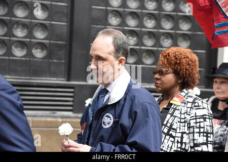 New York City, United States. 23rd Mar, 2016. NYC central labor council president Vincent Alvarez prepares to lay rose. Members of organized labor, community & religious leaders gathered in Greenwich Village to commemorate the 105th anniversary of the Triangle Shirtwaist Company fire, that killed 147 workers in 1911 Credit:  Andy Katz/Pacific Press/Alamy Live News Stock Photo