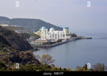 Ehime, Japan. 23rd Mar, 2016. Shikoku Electric Power Co.'s Ikata nuclear power plant reactor buildings one (R), two (C) and three (L) stand at Ikata town in Ehime prefecture, Japan's southern island of Shikoku on Wednesday, March 23, 2016. Japan's nuclear regulation authority approved to reactivate Ikata's reactor three on March 23 despite lingering safety concerns from the 2011 Fukushima nuclear accident. © Yoshio Tsunoda/AFLO/Alamy Live News Stock Photo