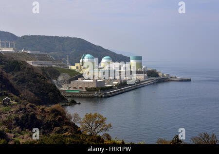 Ehime, Japan. 23rd Mar, 2016. Shikoku Electric Power Co.'s Ikata nuclear power plant reactor buildings one (R), two (C) and three (L) stand at Ikata town in Ehime prefecture, Japan's southern island of Shikoku on Wednesday, March 23, 2016. Japan's nuclear regulation authority approved to reactivate Ikata's reactor three on March 23 despite lingering safety concerns from the 2011 Fukushima nuclear accident. © Yoshio Tsunoda/AFLO/Alamy Live News Stock Photo