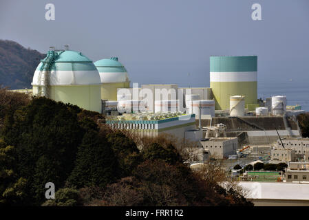 Ehime, Japan. 23rd Mar, 2016. Shikoku Electric Power Co.'s Ikata nuclear power plant reactor buildings one (R), two (C) and three (L) stand at Ikata town in Ehime prefecture, Japan's southern island of Shikoku on Wednesday, March 23, 2016. Japan's nuclear regulation authority approved to reactivate Ikata's reactor three on March 23 despite lingering safety concerns from the 2011 Fukushima nuclear accident. © Yoshio Tsunoda/AFLO/Alamy Live News Stock Photo