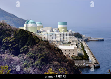 Ehime, Japan. 23rd Mar, 2016. Shikoku Electric Power Co.'s Ikata nuclear power plant reactor buildings one (R), two (C) and three (L) stand at Ikata town in Ehime prefecture, Japan's southern island of Shikoku on Wednesday, March 23, 2016. Japan's nuclear regulation authority approved to reactivate Ikata's reactor three on March 23 despite lingering safety concerns from the 2011 Fukushima nuclear accident. © Yoshio Tsunoda/AFLO/Alamy Live News Stock Photo