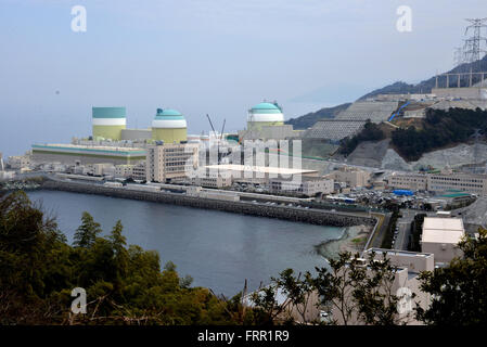 Ehime, Japan. 23rd Mar, 2016. Shikoku Electric Power Co.'s Ikata nuclear power plant reactor buildings one (L), two (C) and three (R) stand at Ikata town in Ehime prefecture, Japan's southern island of Shikoku on Wednesday, March 23, 2016. Japan's nuclear regulation authority approved to reactivate Ikata's reactor three on March 23 despite lingering safety concerns from the 2011 Fukushima nuclear accident. © Yoshio Tsunoda/AFLO/Alamy Live News Stock Photo