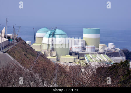 Ehime, Japan. 23rd Mar, 2016. Shikoku Electric Power Co.'s Ikata nuclear power plant reactor buildings one (R), two (L) and three (C) stand at Ikata town in Ehime prefecture, Japan's southern island of Shikoku on Wednesday, March 23, 2016. Japan's nuclear regulation authority approved to reactivate Ikata's reactor three on March 23 despite lingering safety concerns from the 2011 Fukushima nuclear accident. © Yoshio Tsunoda/AFLO/Alamy Live News Stock Photo