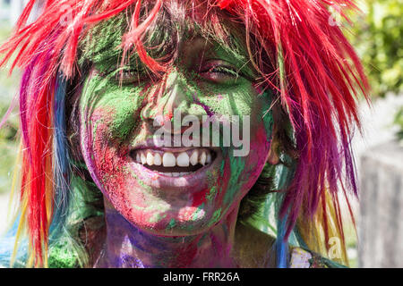 Sivasagar, Assam, India. 24th Mar, 2016. An Indian woman's face is smeared with colored powder during celebrations of the Holi festival in the Sivasagar district of northeastern Assam state on March 24, 2016. Holi, the festival of colours, is a riotous celebration of the coming of spring and falls on the day after full moon annually in March. Revellers spray coloured powder and water on each other with great gusto, whilst adults extend the hand of peace. Credit:  Luit Chaliha/ZUMA Wire/Alamy Live News Stock Photo