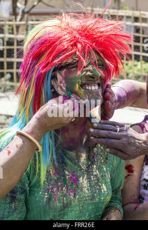 Sivasagar, Assam, India. 24th Mar, 2016. An Indian woman's face is smeared with colored powder during celebrations of the Holi festival in the Sivasagar district of northeastern Assam state on March 24, 2016. Holi, the festival of colours, is a riotous celebration of the coming of spring and falls on the day after full moon annually in March. Revellers spray coloured powder and water on each other with great gusto, whilst adults extend the hand of peace. Credit:  Luit Chaliha/ZUMA Wire/Alamy Live News Stock Photo