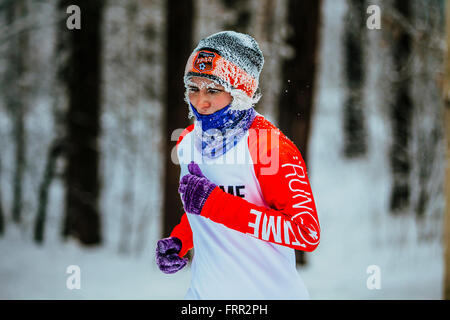 closeup face in frost elderly woman athletes running in cold weather in winter woods during Chelyabinsk winter marathon Stock Photo