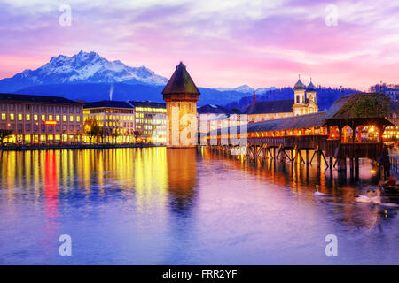 Chapel bridge, Water tower and Mount Pilatus on sunset, Lucerne, Switzerland. Stock Photo