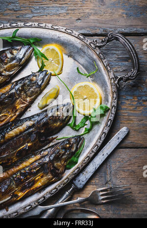 Mackerels served on silver plate with lemon Stock Photo