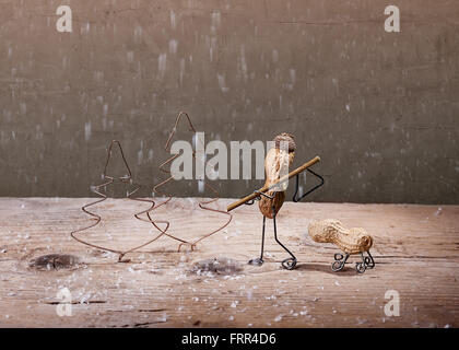 Simple Things - Miniature with Peanut People in the Forest to Fell a Christmas Tree Stock Photo