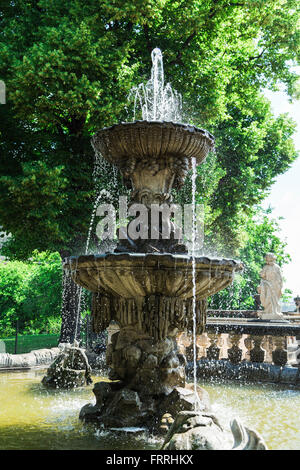 Majestic antique stone fountain in the courtyard of ancient castle Stock Photo