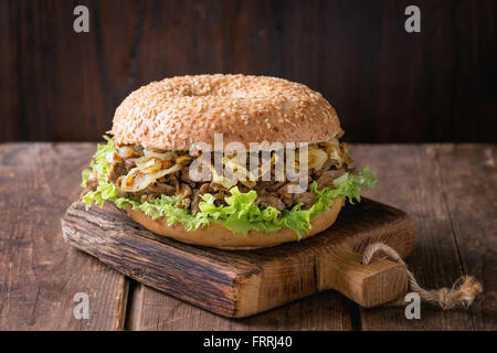 Bagel with stew and fried onion Stock Photo