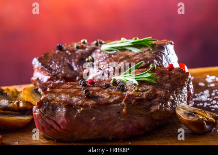 Steak. Grill beef steak. Portions thick beef juicy sirloin steaks on grill teflon pan or granite board. Stock Photo
