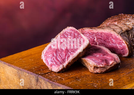 Steak. Grill beef steak. Portions thick beef juicy sirloin steaks on grill teflon pan or granite board. Stock Photo