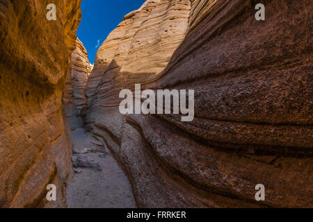 Hiking through the narrow slot canyon along the Slot Canyon Trail at Kasha-Katuwe Tent Rocks National Monument in New Mexico, US Stock Photo