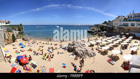 CASCAIS, PORTUGAL - JUNE 13, 2013: People sunbathing on the Praia da Rainha beach on June 13, 2013 in Cascais, Portugal Stock Photo