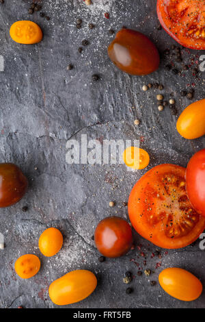 Tomatoes mix  with seasoning on the stone table Stock Photo