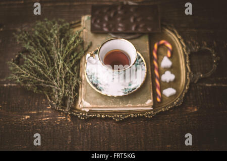 Tea set with  blurred herb and chocolate on the wooden table horizontal Stock Photo