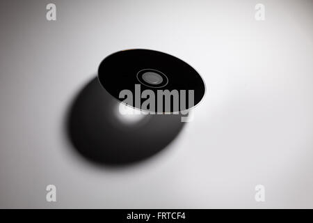 a CD , DVD disk with dark shadow , technology concept Stock Photo - Alamy