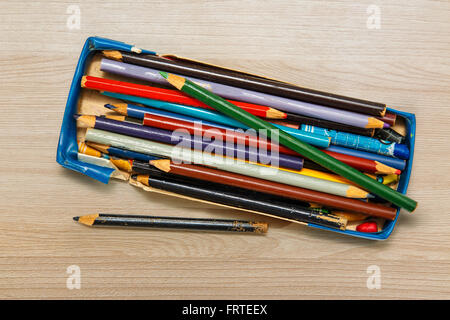 Color pencils in a box on wooden background Stock Photo