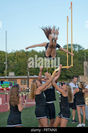 Emporia, Kansas, USA, 9th September, 2015 Emporia State University pep rally at Welch Stadium.  Cheerleader Destiny Hall a senior Elementary Education student from Wichita shows off her flying skills.  She was tossed by follow students Cailin Caldwell Junior Elementary education student from Lawrence, Amada Duncun Secondry education sophomore from Melissa, Texas, Kalyn Meske accounting junior from Shawnee, Kansas and Justin Ward, sophomore athletic training student from Manhattan Kansas.  Credit: Mark Reinstein Stock Photo