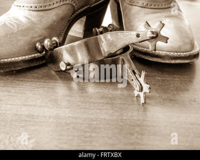 Boots and spurs; wood foreground Stock Photo