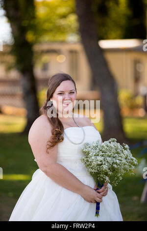 Portrait of a bride in her wedding dress outdoors in Oregon at a yacht club marina. Stock Photo